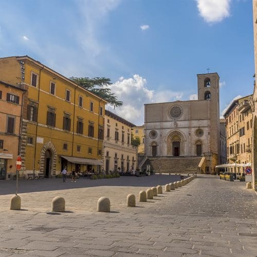 A view across the main square towards the cathedral in the medieval city of Todi, Umbria, Italy in summer